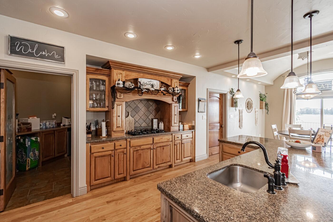 Open kitchen with rich cabinetry and granite countertops