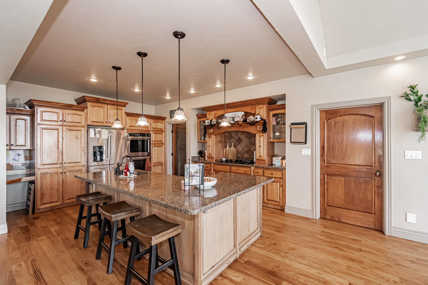 Kitchen with granite countertops and rich wood cabinetry